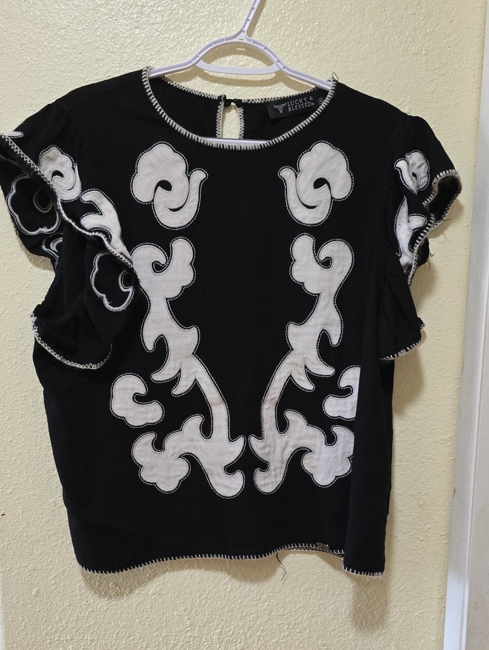 Lucky & Blessed Black Top with White Floral Appliqué and Flutter Sleeves